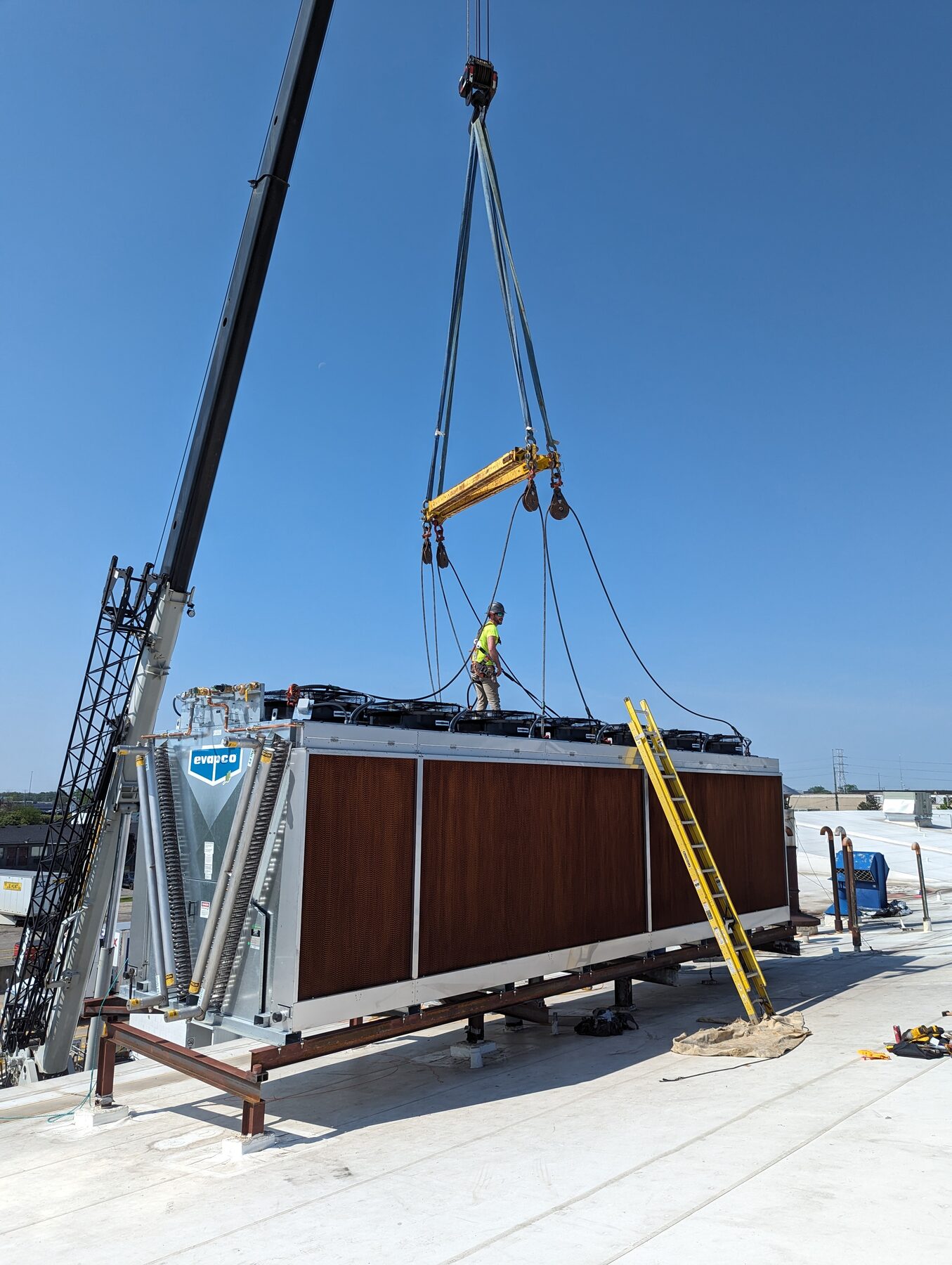 Crew performing maintenance rigging work on plant equipment